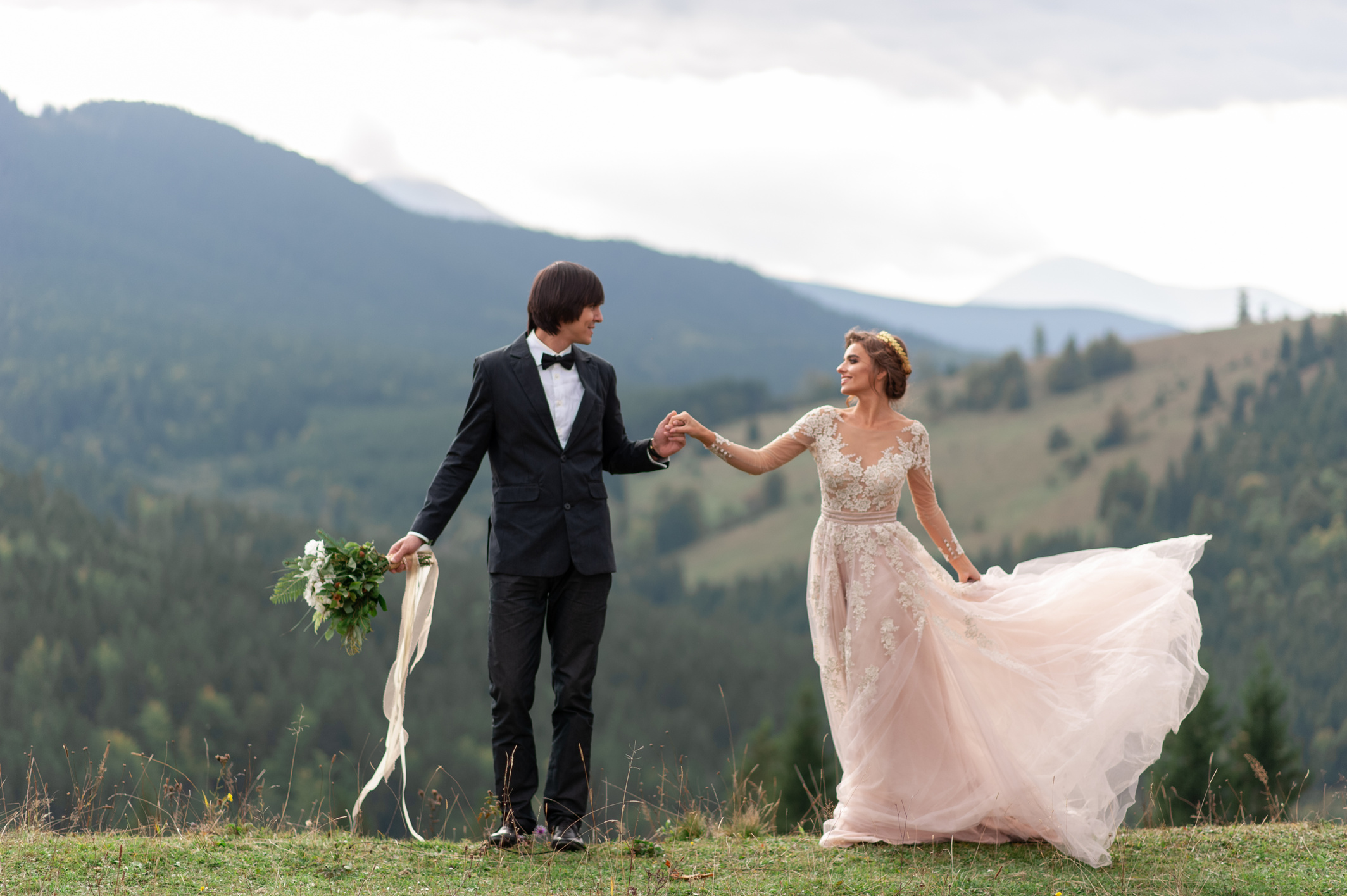 The bride and groom celebrate their wedding in the mountains. Wedding photography. Wedding ceremony for two.